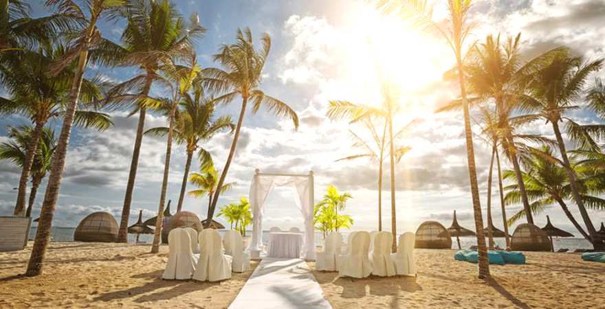 Ein weißer Baldachin und weiße Stühle am Strand auf Mauritius