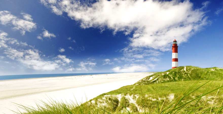 Ein Leuchtturm in den Dünen am Strand