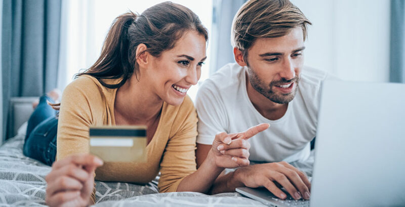 Paar beim Online-Shopping vor Laptop mit Kreditkarte