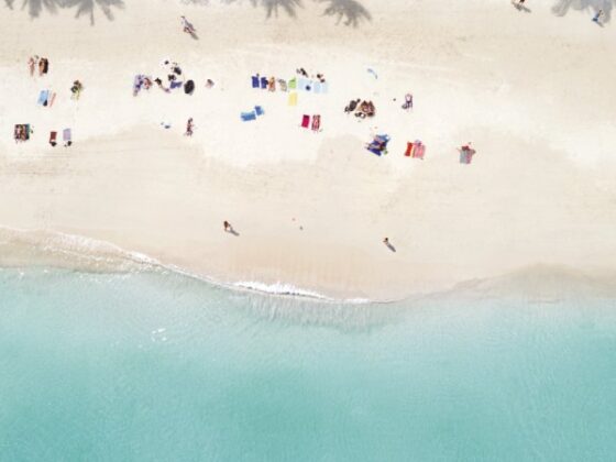 Strandabschnitt in Koh Phangan von Oben mit vielen kleinen Strandbesuchern auf Badetüchern