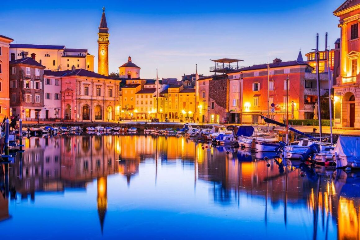 Piran, Slowenien - Marina Dämmerungsansicht mit Spiegelung der St. Georgskirche