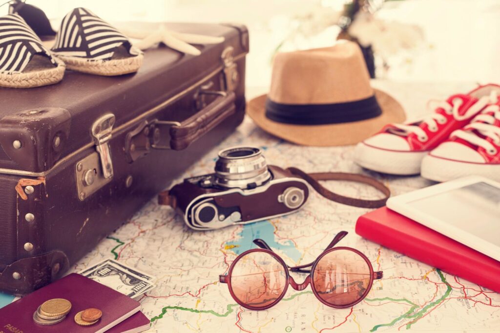 Urlaub statt Erkältung: Mit diesen 8 Tipps bleiben Sie entspannt und erholt auf Reisen Koffer und Gepäck auf einer Landkarte