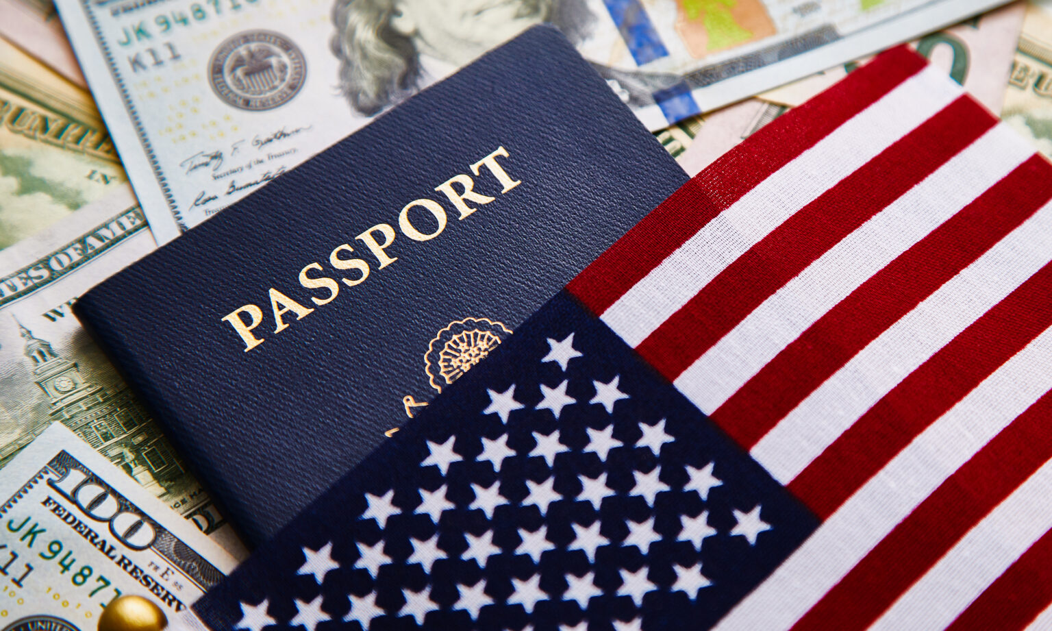 USA-Einreise ab November 2026: Erklärung zu Kongo-Aufenthalt wird Pflicht Amerikanischer Pass und amerikanische Flagge liegen auf Dollarscheinen